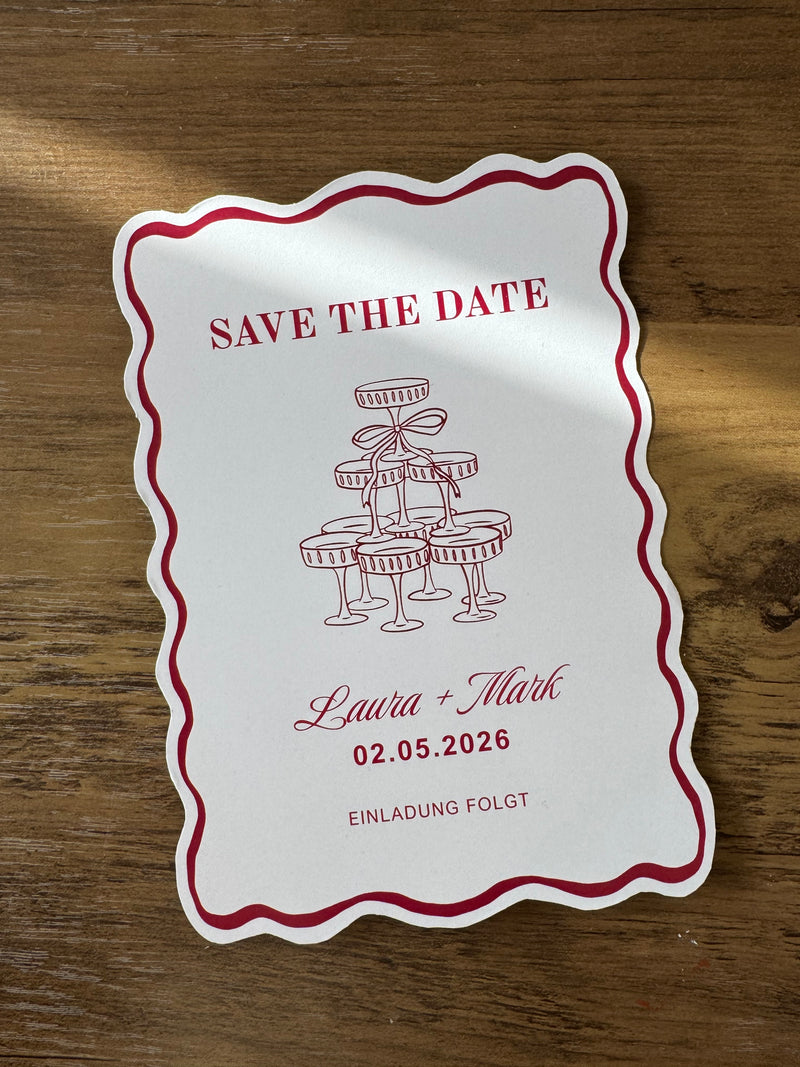 Bordeaux Save the Date card with a illustration of a glasses of champagne tower.