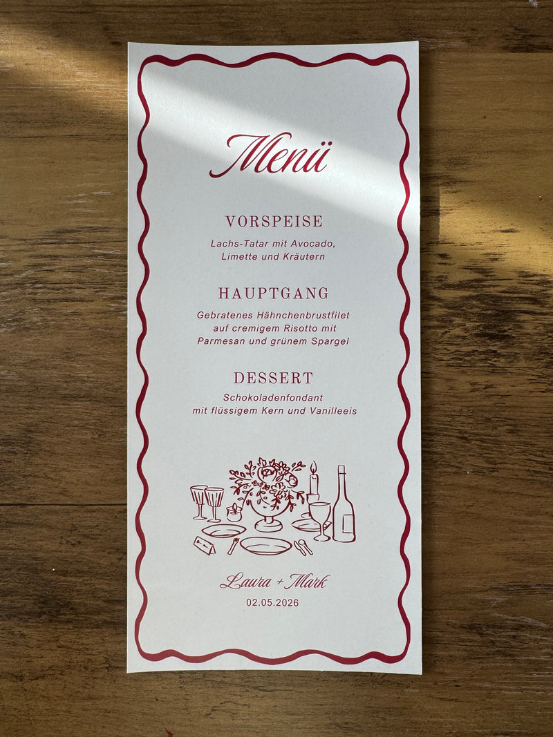 White wedding menu with bordeaux text and illustrations on a wooden surface