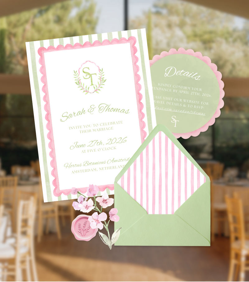 Wedding invitation card with pink and green design in a blurred indoor setting