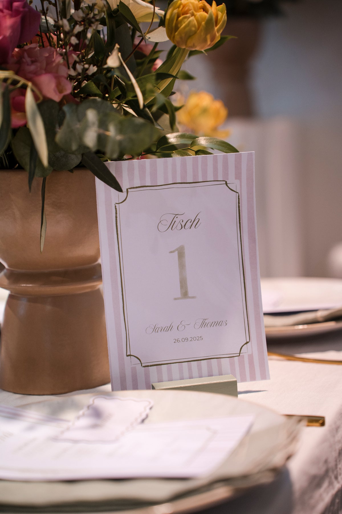 Table number card with floral arrangement on a table setting